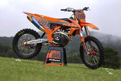 DeCal Works Think It. Create It. 221 Design Dirt Bike Graphics. Solid Orange and Grey Design with Black and Orange Gripper and Ribbed Seat Cover.
