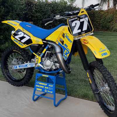Yellow and blue RM125 Dirt Bike in DeCal Works Project Bike Gallery sitting on a blue bike stand