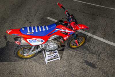 Dubya's Trick Build Honda CRF110 Factory Works Dirt Bike with Red and blue graphics.