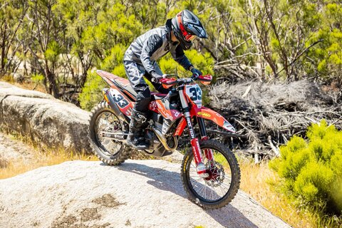 2023 KTM 350 XC-F with red and black dirt bike graphics and black #33 on a white number plate background