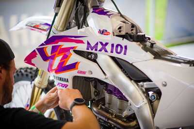 Purple and white throw back yamaha complete dirt bike graphics installing a radiator shroud decal with YZ logo